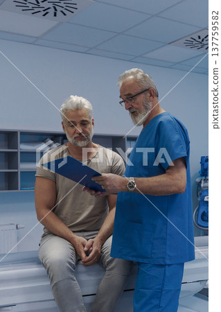 Doctor explaining CT scan results to patient in hospital setting Doctor explaining CT scan results to patient in hospital setting 137759582
