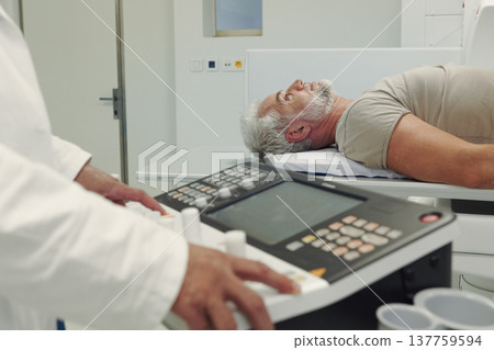 Doctor operationg CT machine in hospital. Doctor operationg CT machine in hospital. 137759594