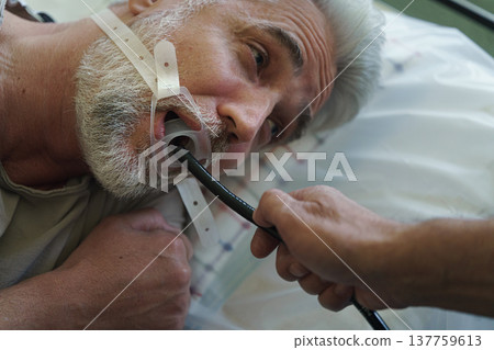 Gastroscopy procedure on sedated patient to examine upper digestive tract. 137759613