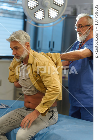 Doctor examining patient, listening to breathing with stethoscope. Doctor examining patient, listening to breathing with stethoscope. 137759635