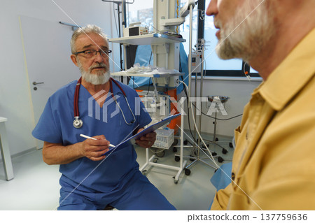 Patient sitting on examination table, describing symptoms to doctor. Patient sitting on examination table, describing symptoms to doctor. 137759636