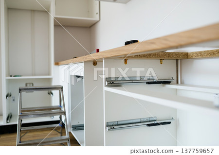 Installing kitchen countertop and sink during kitchen renovation. 137759657