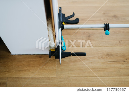 Close up on clamps on door frame during home renovation. Close up on clamps on door frame during home renovation. 137759667