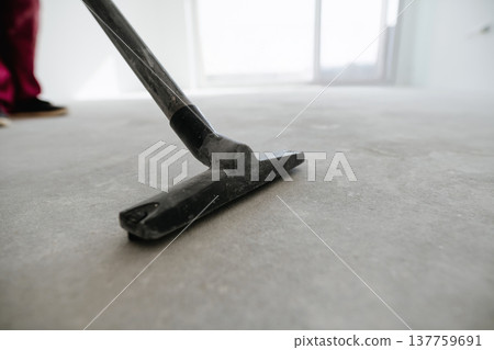 Vacuum cleaning concrete floor before installing flooring. Vacuum cleaning concrete floor before installing flooring. 137759691