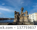 24 Feb 2026,Prague, Czech Republic. Baroque statues on the historic Charles Bridge with tourists walking across Vltava River against a beautiful cloudy sky 137759837