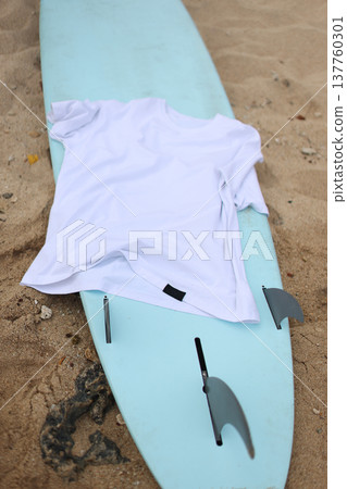 Sand Surface With Branded Apparel. Casual Beach Clothing Presentation On Sandy Surface With Fins Sand Surface With Branded Apparel. Casual Beach Clothing Presentation On Sandy Surface With Fins 137760301