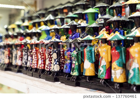 Miniature Vietnamese figurines in traditional dress at souvenir shop Miniature Vietnamese figurines in traditional dress at souvenir shop 137760461