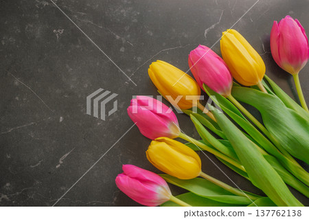 Luxury spring mix of yellow and pink tulips on a dark marble background. Vibrant floral contrast against black stone with light veins and elegant copy space Luxury spring mix of yellow and pink tulips on a dark marble background. Vibrant floral contrast against black stone with light veins and elegant copy space 137762138