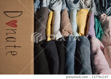 Box filled with neatly folded clothes ready for donation at a local charity for those in need 137762147