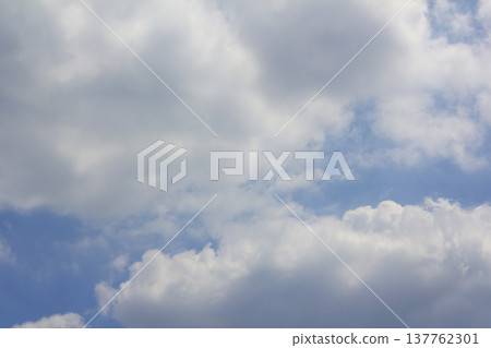It's a blue sky with fluffy clouds. It's a blue sky with fluffy clouds. 137762301