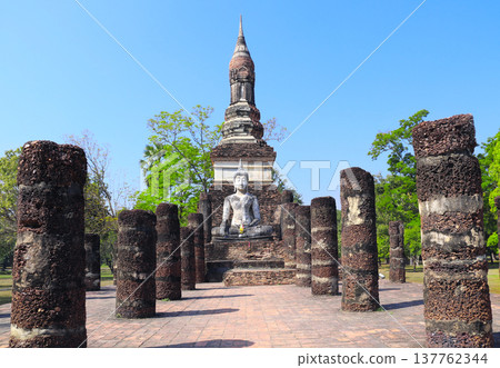 Ancient stone Buddha statue, Wat Sa Si temple, Sukhothai historical park. Picturesque scene with Buddha statuary, Sukhothai old city, Northern Thailand. Topic of vacation, travel, trip, cruise, tour 137762344