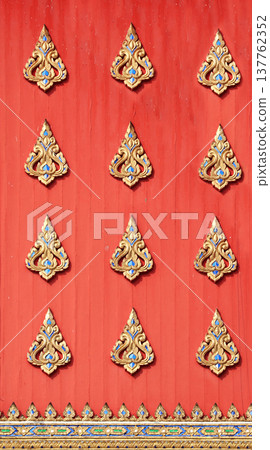 Detail of old wood wall with carved ornament in temple, Thailand. A wooden temple wall decorated with traditional ancient Thai decor Detail of old wood wall with carved ornament in temple, Thailand. A wooden temple wall decorated with traditional ancient Thai decor 137762352