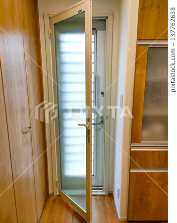 Double doors at the kitchen back entrance, letting in sunlight. 137762638