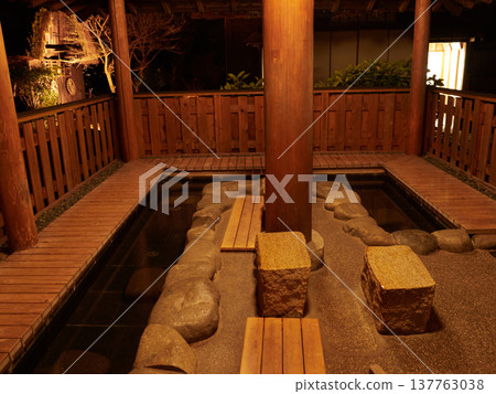 A night view of the footbath at Gero Gassho Village, a popular tourist spot in Gifu Prefecture, Japan, during winter. A night view of the footbath at Gero Gassho Village, a popular tourist spot in Gifu Prefecture, Japan, during winter. 137763038