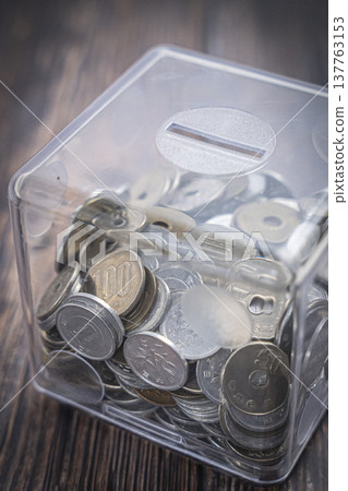 Coins in a case, Japanese yen piggy bank 137763153
