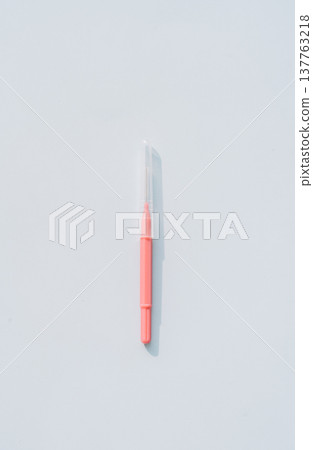 Single interdental brush on light blue background, dental cleaning tool flat lay with copy space 137763218