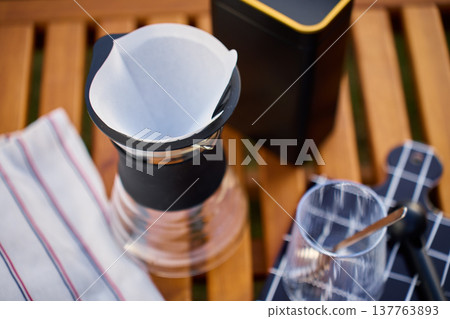 Pour over coffee setup with empty paper filter in dripper outdoors 137763893