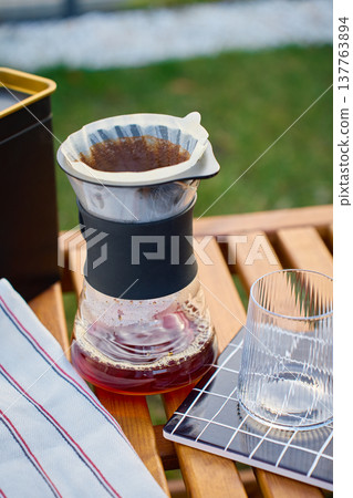 Pour over coffee dripper on glass carafe with empty serving glass 137763894
