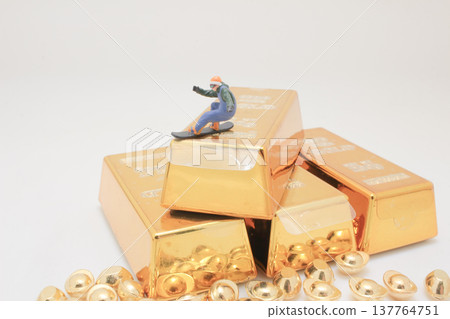 Miniature snowboarder descends gold bar slope in dynamic pose Miniature snowboarder descends gold bar slope in dynamic pose 137764751