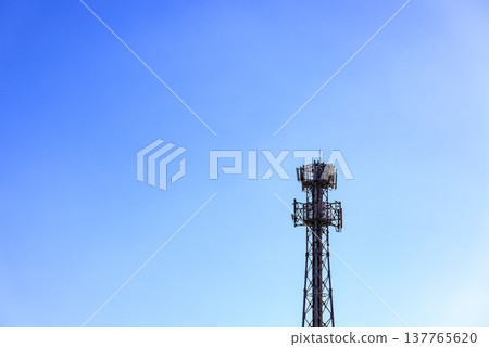 Wireless Communication Antenna pole, Mobile phone mast antenna pole on top of dilapidated building. 137765620