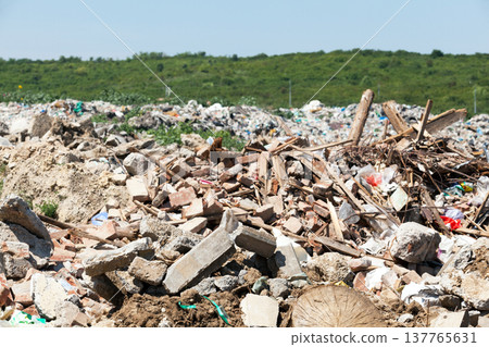 Municipal garbage dump at landfill. Environmental pollution. 137765631