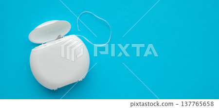 dental floss in case on blue background dental floss in case on blue background 137765658