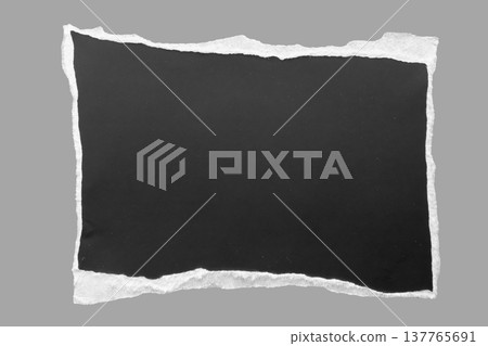 piece of black paper tear isolated on gray background piece of black paper tear isolated on gray background 137765691