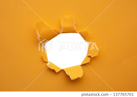 Torn ripped orange paper hole isolated on white background 137765701