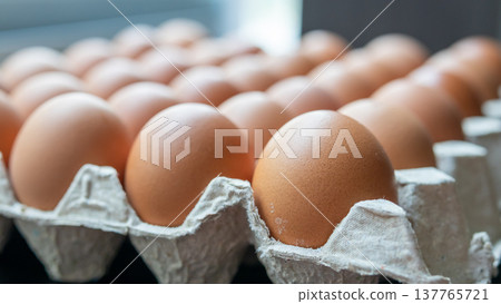 Fresh organic brown chicken eggs in cardboard tray Fresh organic brown chicken eggs in cardboard tray 137765721