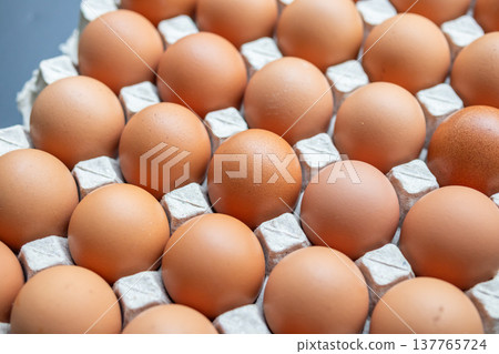 Fresh organic brown chicken eggs in cardboard tray 137765724