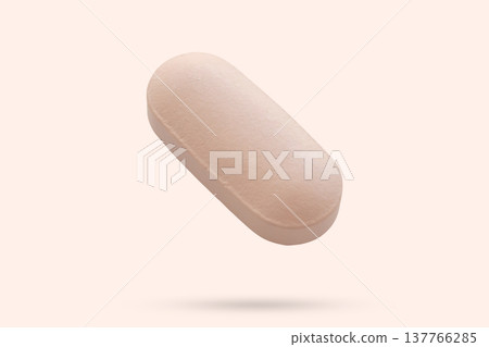 Pink medicine pill tablet float on beige background Pink medicine pill tablet float on beige background 137766285