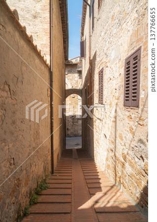 Narrow stone street between historic buildings in european old town. Visual supports heritage tourism, urban history education, travel storytelling Narrow stone street between historic buildings in european old town. Visual supports heritage tourism, urban history education, travel storytelling 137766655