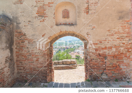 Historic stone archway framing rural landscape in european heritage town. Image supports cultural education, tourism promotion, architecture storytelling and travel editorial content Historic stone archway framing rural landscape in european heritage town. Image supports cultural education, tourism promotion, architecture storytelling and travel editorial content 137766688