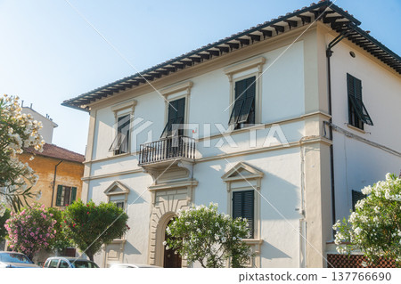 Elegant two-story villa in Tuscany with classic facade and bright daylight. European residential architecture and travel inspiration Elegant two-story villa in Tuscany with classic facade and bright daylight. European residential architecture and travel inspiration 137766690