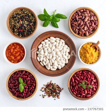 Vibrant topdown view of various beans and legumes in clay bowls. Perfect for healthy eating, vegan recipes, and culinary marketing. A clean, rustic aesthetic for proteinrich diets. 137767381