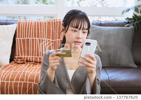 Woman making online payment with smartphone 137767620