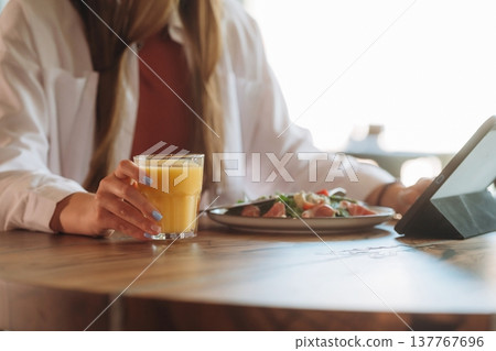 Close up view of teenage girl that is sitting in the cafe restaurant Close up view of teenage girl that is sitting in the cafe restaurant 137767696