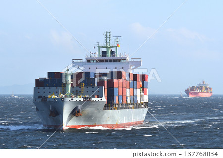 A container ship sailing through rough seas. A container ship sailing through rough seas. 137768034