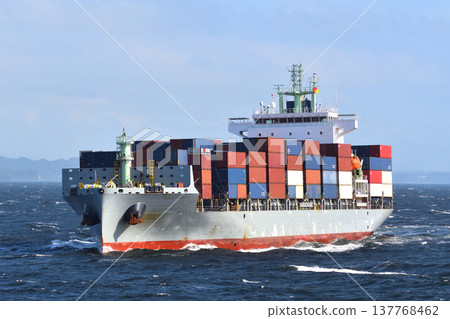A container ship sailing through rough seas. A container ship sailing through rough seas. 137768462
