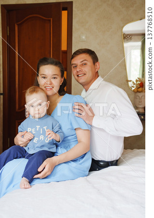 Family portrait in a cozy home setting during the day Family portrait in a cozy home setting during the day 137768510