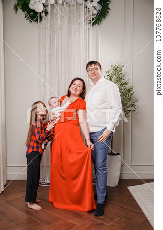 Family celebration in a decorated indoor space with kids and baby 137768628
