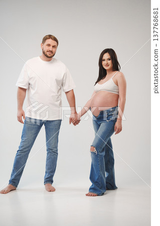 New parents pose together in studio setting New parents pose together in studio setting 137768681