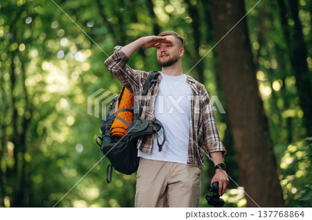 Male tourist is with backpack in the forest 137768864
