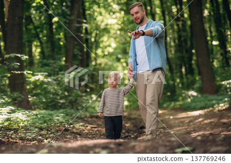 Dad with his little boy son is in the forest Dad with his little boy son is in the forest 137769246