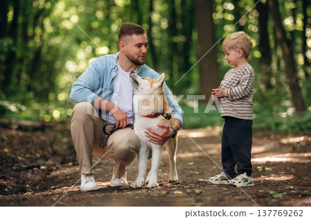 Father with son and dog are in the forest 137769262