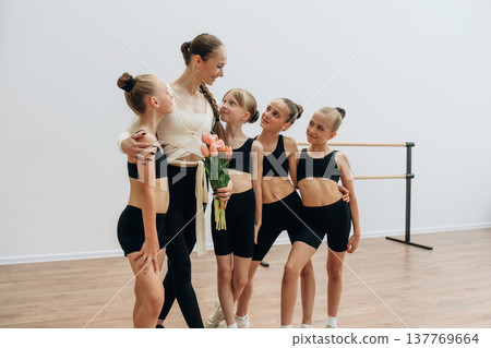 Break time. Trainer is teaching girls ballet dancing 137769664
