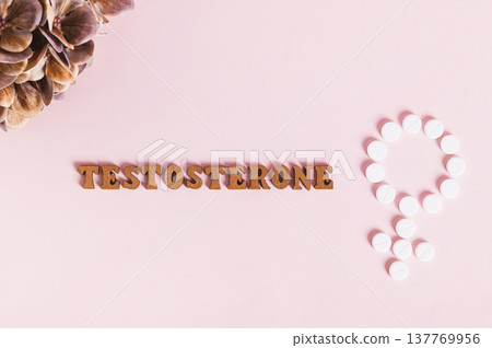 Close up of testosterone, medication for women therapy on pink background top view Close up of testosterone, medication for women therapy on pink background top view 137769956