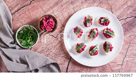Eggs delived with vegetable salad, a piece of herring and arugula on a plate top view web banner Eggs delived with vegetable salad, a piece of herring and arugula on a plate top view web banner 137769967