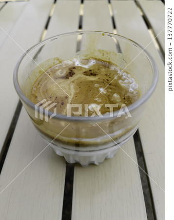 Glass of espresso shot over cold fresh milk 137770722