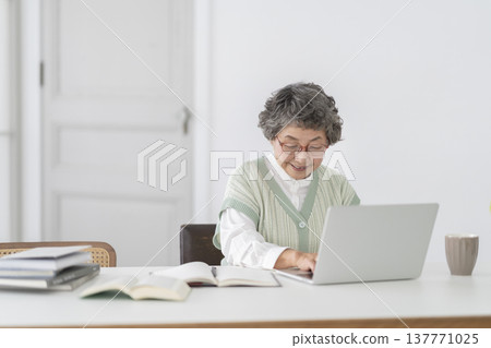 Senior woman doing desk work Senior woman doing desk work 137771025